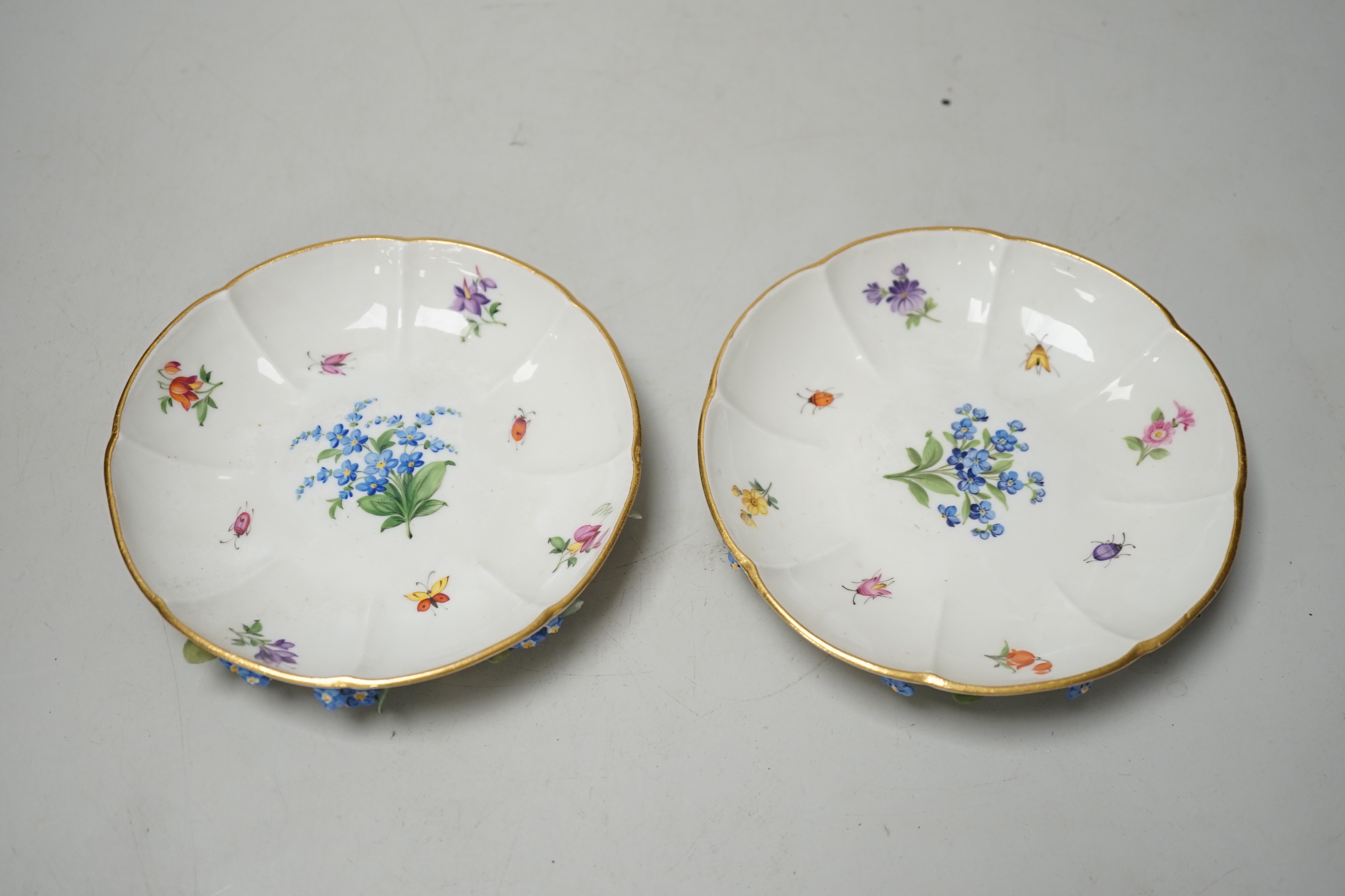 A pair of Meissen floral-encrusted cabinet cups and saucers, late 19th century, saucers 14cm diam.